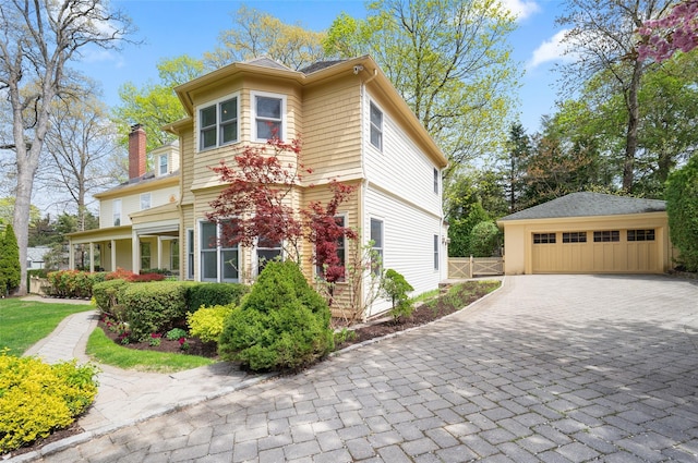 66 Drake Rd, Scarsdale, NY 10583 - view of front of property with a detached garage, an outbuilding, a chimney, and fence