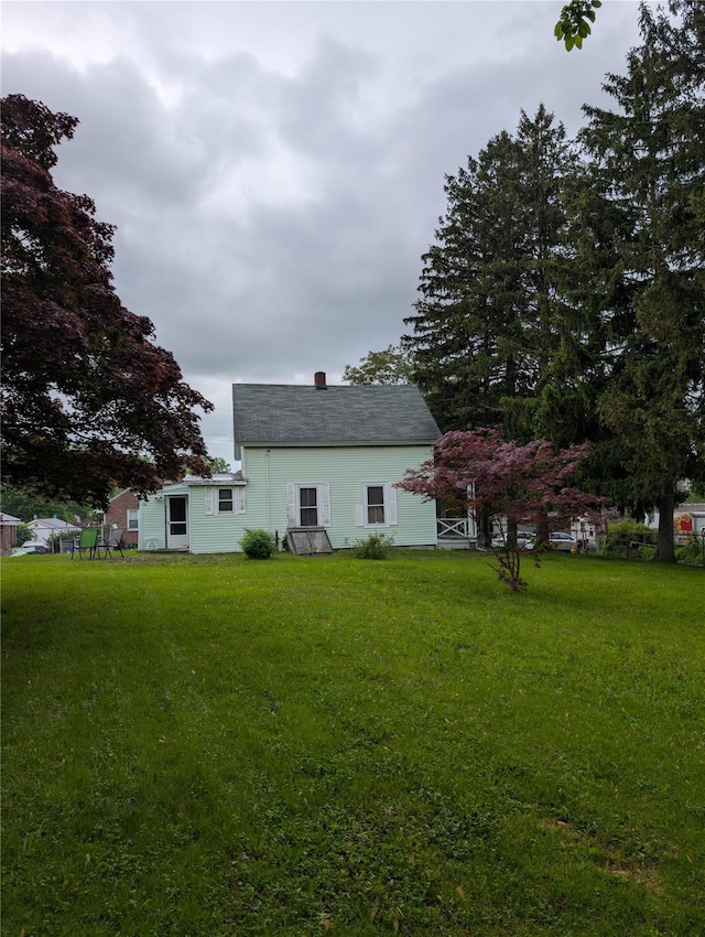 45 Clancy Ave, New Windsor, NY 12553 - back of house with a lawn and a chimney