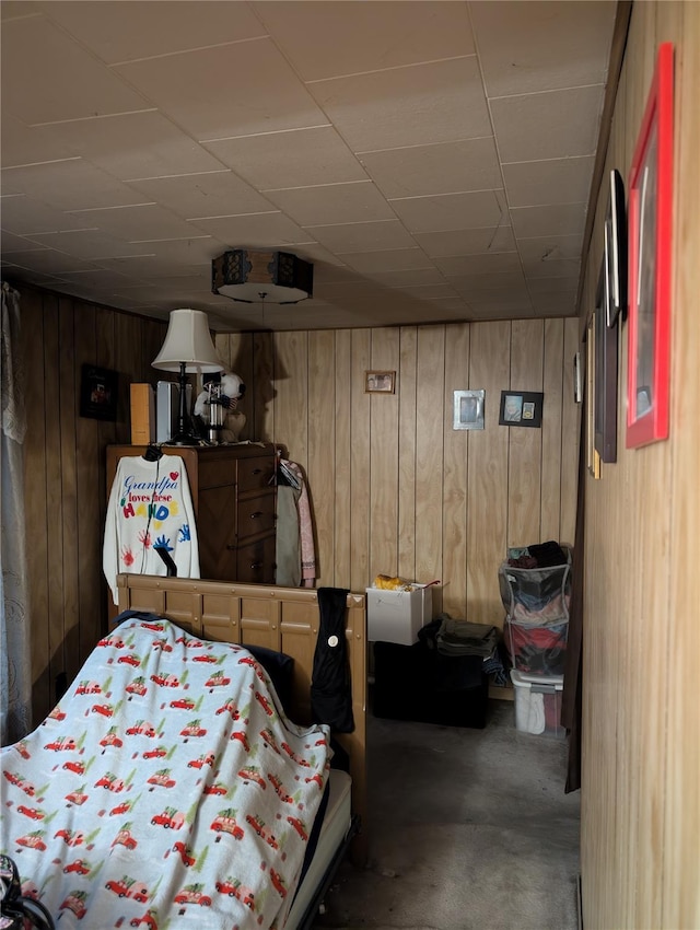 45 Clancy Ave, New Windsor, NY 12553 - bedroom featuring wood walls, a paneled ceiling, and concrete floors