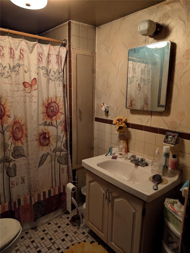 45 Clancy Ave, New Windsor, NY 12553 - bathroom with tile walls, vanity, wallpapered walls, a wainscoted wall, and toilet