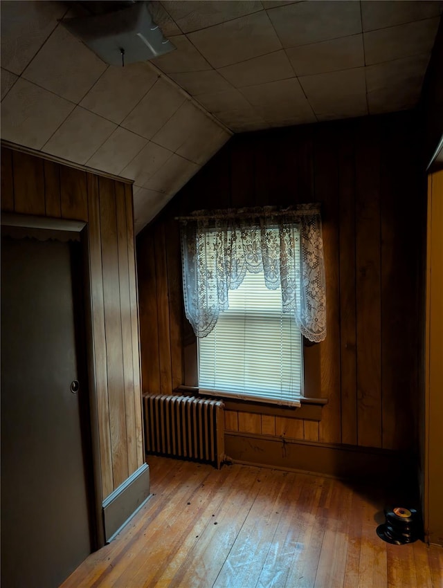 45 Clancy Ave, New Windsor, NY 12553 - additional living space with radiator heating unit, hardwood / wood-style flooring, wood walls, and vaulted ceiling