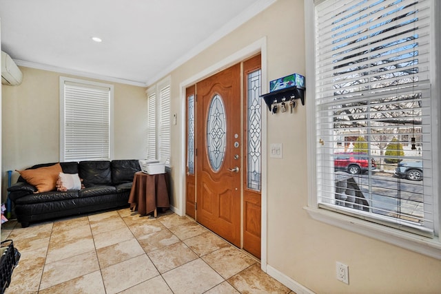 foyer entrance featuring light tile patterned floors, baseboards, crown molding, and a wall unit AC