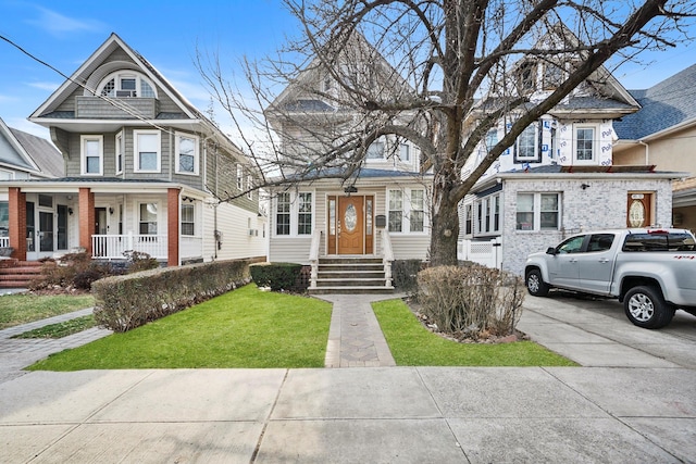 view of front of house with concrete driveway and a front lawn