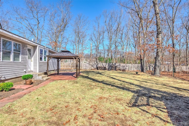 view of yard with entry steps, a gazebo, and fence