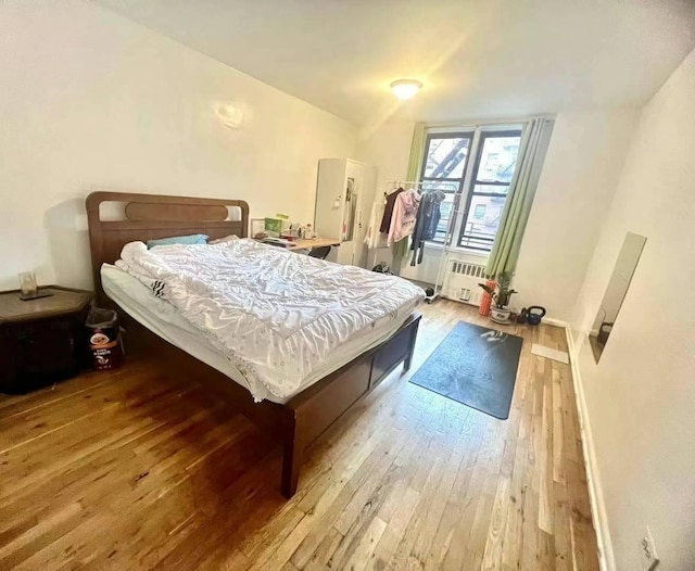 bedroom featuring baseboards and wood-type flooring