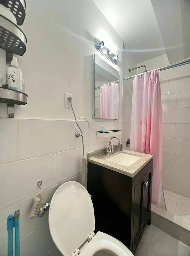 full bath with tile patterned flooring, tile walls, toilet, and a stall shower