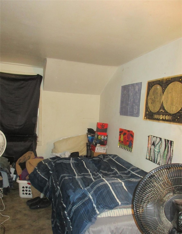 bedroom with carpet flooring and lofted ceiling