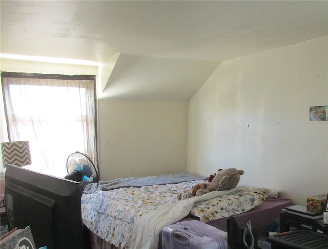 bedroom featuring lofted ceiling