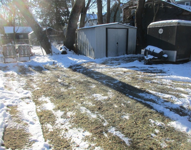 exterior space with an outbuilding, a storage unit, and fence