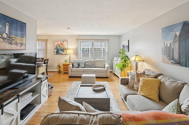 living area featuring baseboard heating and light wood finished floors