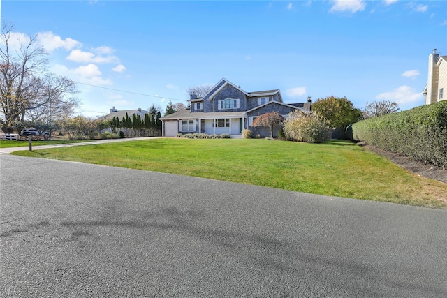 118 Paquatuck Ave, East Moriches, NY 11940 - shingle-style home featuring driveway, a front yard, and a garage