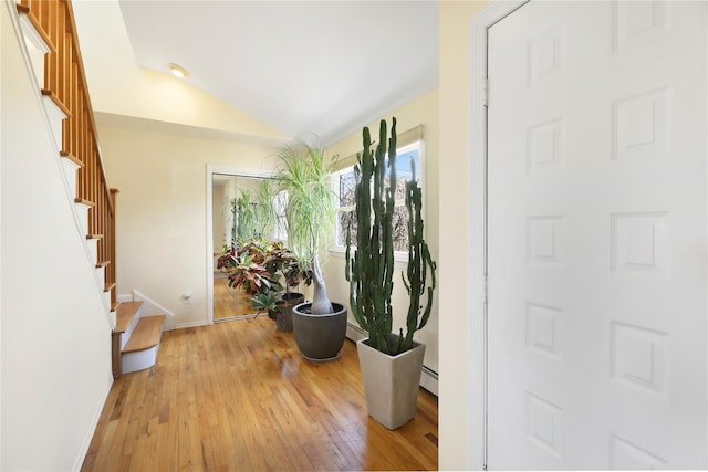 118 Paquatuck Ave, East Moriches, NY 11940 - foyer entrance featuring hardwood / wood-style floors, lofted ceiling, baseboards, and stairway