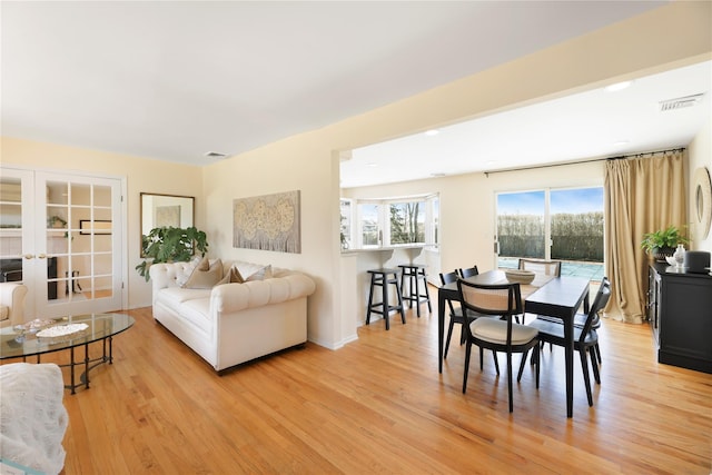 118 Paquatuck Ave, East Moriches, NY 11940 - dining space featuring baseboards, visible vents, light wood-style floors, and french doors