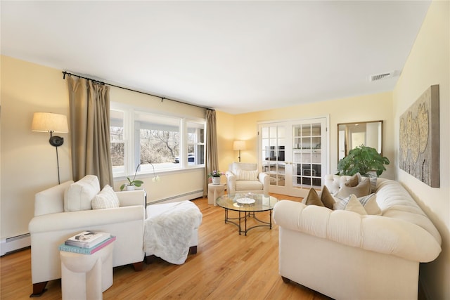 118 Paquatuck Ave, East Moriches, NY 11940 - living room with a baseboard radiator, visible vents, and light wood-type flooring