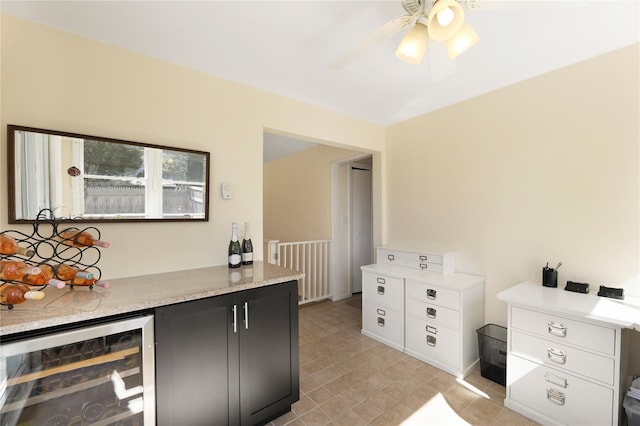 118 Paquatuck Ave, East Moriches, NY 11940 - kitchen with wine cooler, ceiling fan, and dark cabinetry