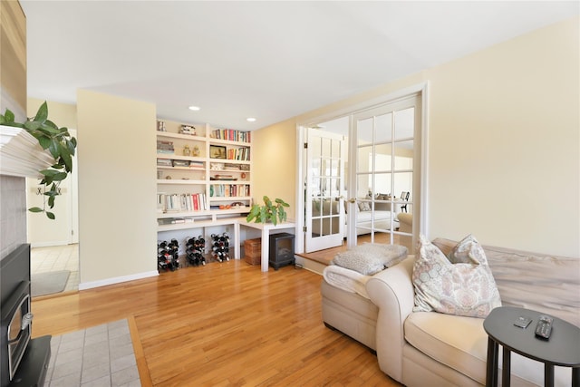 118 Paquatuck Ave, East Moriches, NY 11940 - living area featuring a wood stove, french doors, recessed lighting, and light wood-type flooring