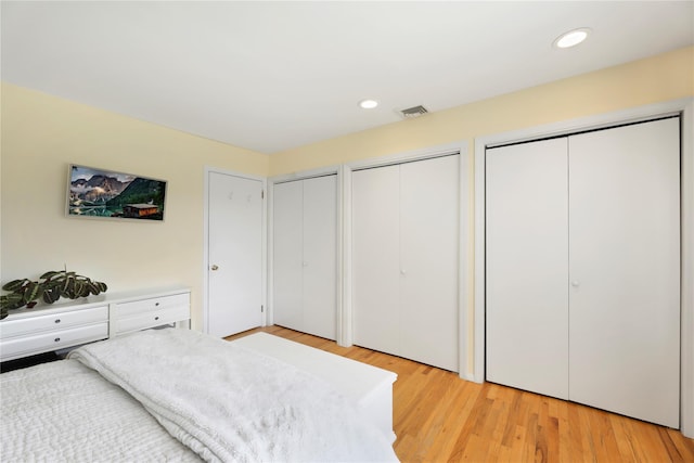 118 Paquatuck Ave, East Moriches, NY 11940 - bedroom featuring light wood-style flooring, recessed lighting, multiple closets, and visible vents