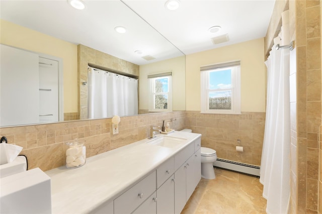 118 Paquatuck Ave, East Moriches, NY 11940 - full bath with tile walls, toilet, recessed lighting, vanity, and baseboard heating
