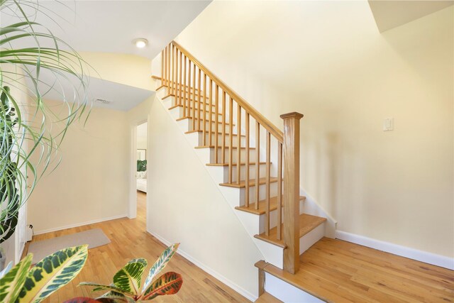 118 Paquatuck Ave, East Moriches, NY 11940 - staircase with baseboards, visible vents, wood finished floors, and lofted ceiling
