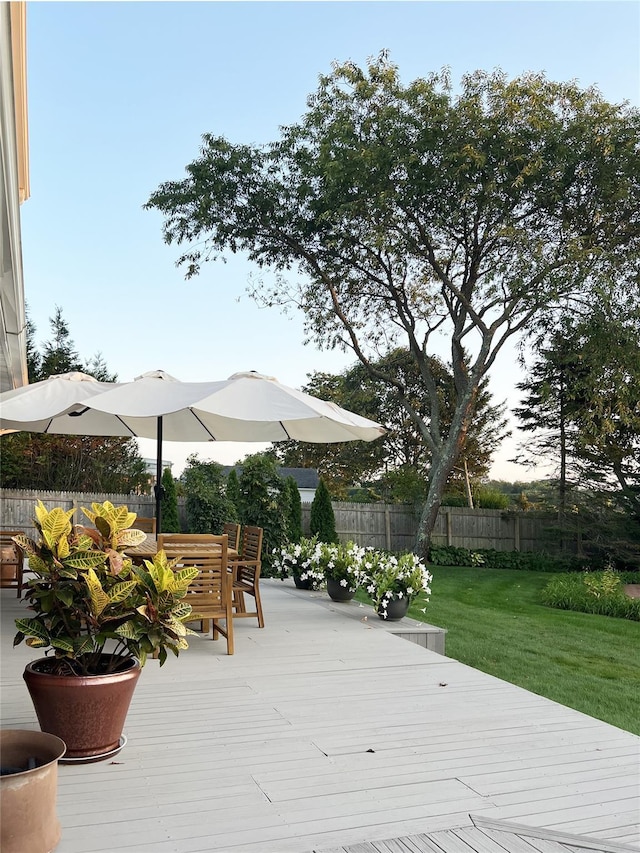 118 Paquatuck Ave, East Moriches, NY 11940 - deck featuring a lawn, outdoor dining area, and fence