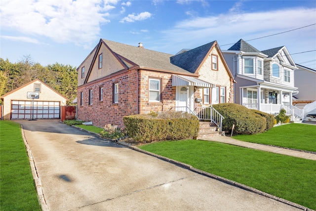 view of front facade featuring an outbuilding, a front yard, a detached garage, and brick siding