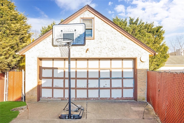 exterior space featuring an outdoor structure, a garage, and fence