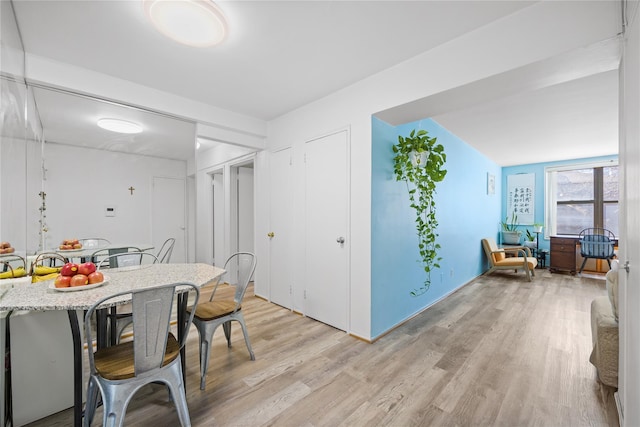 dining space featuring light wood-style floors