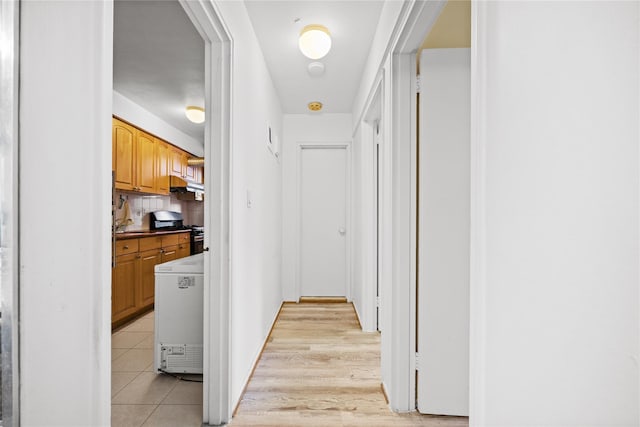 corridor featuring light tile patterned floors