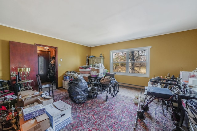 interior space featuring a baseboard heating unit and ornamental molding