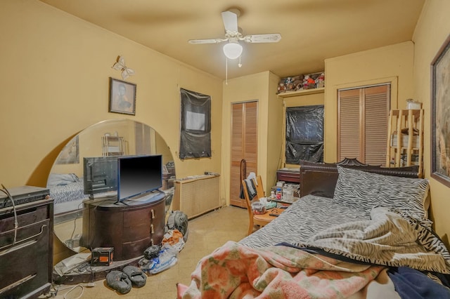 bedroom featuring tile patterned floors, a ceiling fan, and ornamental molding