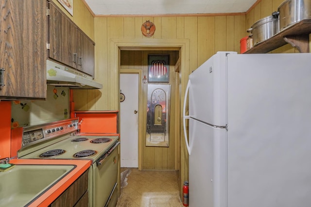 kitchen with range with electric cooktop, under cabinet range hood, freestanding refrigerator, wood walls, and light floors