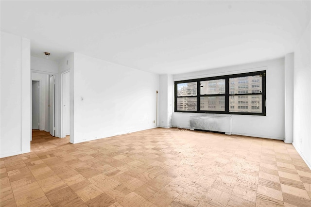 180 W End Ave Unit 23G, New York Manhattan, NY 10023 - spare room featuring radiator heating unit and baseboards