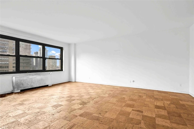 180 W End Ave Unit 23G, New York Manhattan, NY 10023 - empty room featuring radiator heating unit and baseboards