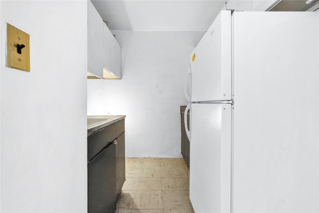 180 W End Ave Unit 23G, New York Manhattan, NY 10023 - kitchen featuring light floors, white cabinets, light countertops, and freestanding refrigerator