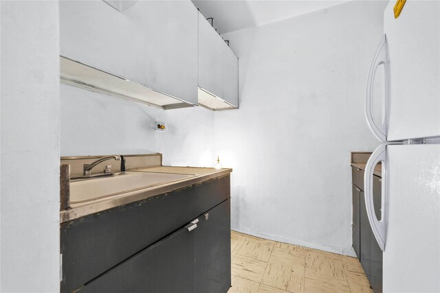 180 W End Ave Unit 23G, New York Manhattan, NY 10023 - kitchen featuring light floors, freestanding refrigerator, and a sink