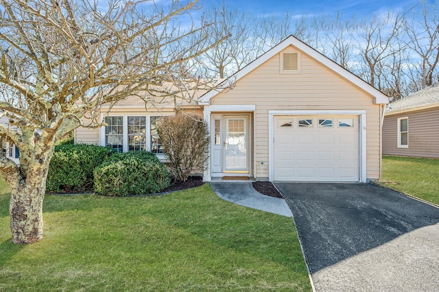 view of front of property featuring aphalt driveway, an attached garage, and a front yard