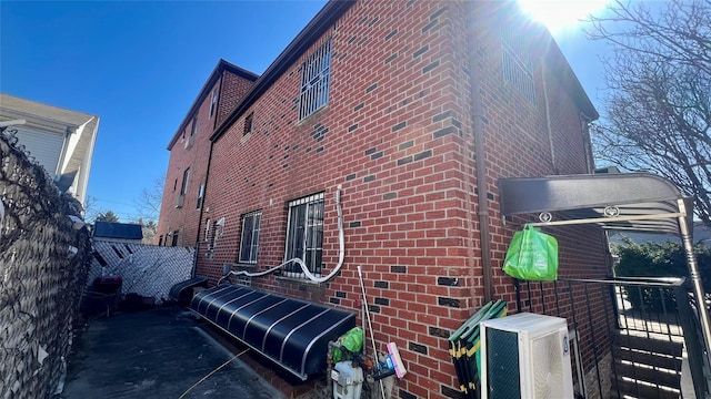 view of property exterior featuring brick siding