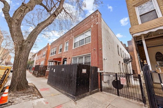 exterior space featuring a fenced front yard and brick siding