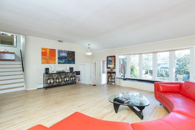 living area with wood finished floors, stairs, and vaulted ceiling