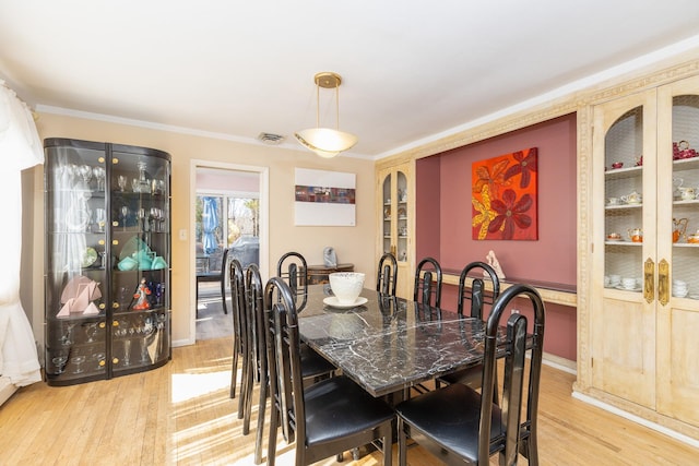 4 Park Pl, Oyster Bay, NY 11771 - dining room featuring visible vents, crown molding, and light wood-style floors