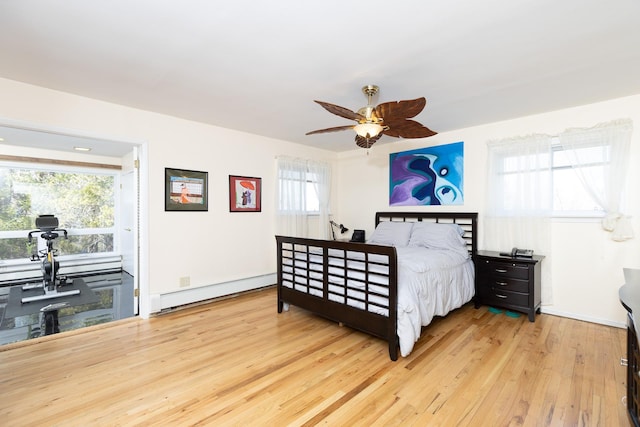 4 Park Pl, Oyster Bay, NY 11771 - bedroom featuring a ceiling fan, multiple windows, wood finished floors, and a baseboard radiator