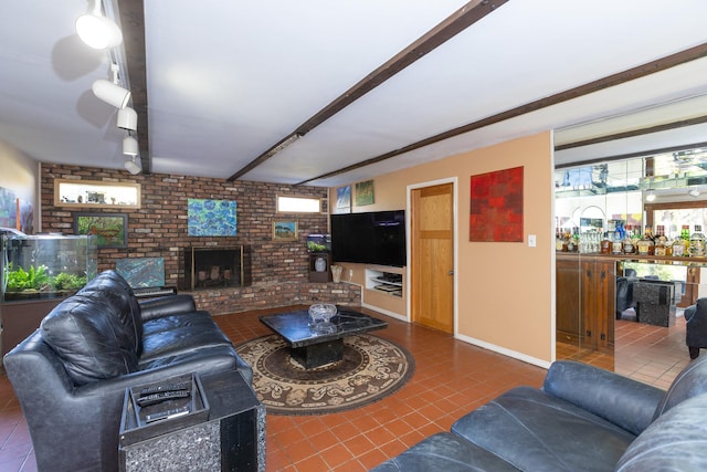 4 Park Pl, Oyster Bay, NY 11771 - tiled living room featuring brick wall, baseboards, beam ceiling, a fireplace, and rail lighting