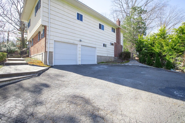 4 Park Pl, Oyster Bay, NY 11771 - view of home's exterior featuring an attached garage and driveway