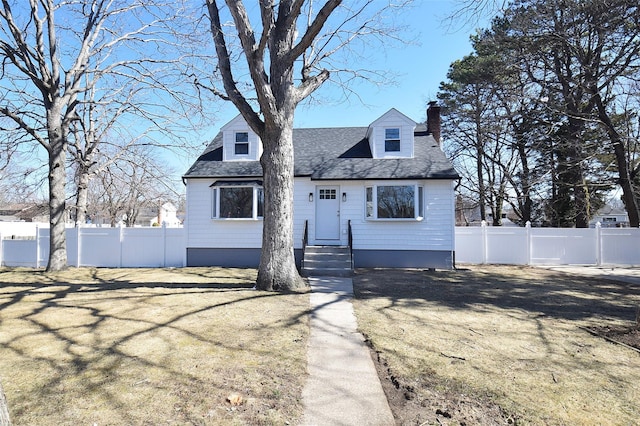 cape cod-style house featuring a front lawn, a shingled roof, a chimney, and fence