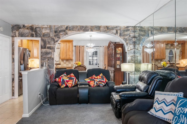 living room featuring light tile patterned flooring, light colored carpet, and a chandelier