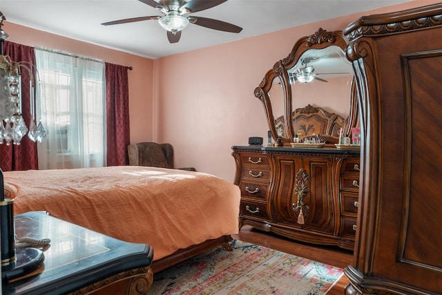 bedroom with a ceiling fan and wood finished floors