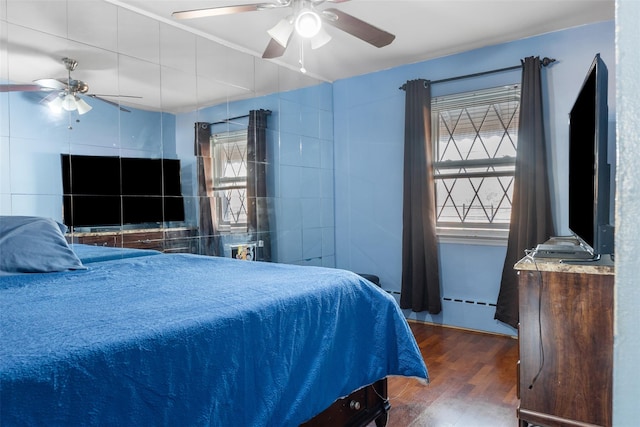 bedroom featuring a ceiling fan and wood finished floors