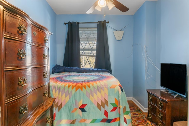 bedroom featuring a ceiling fan and baseboards