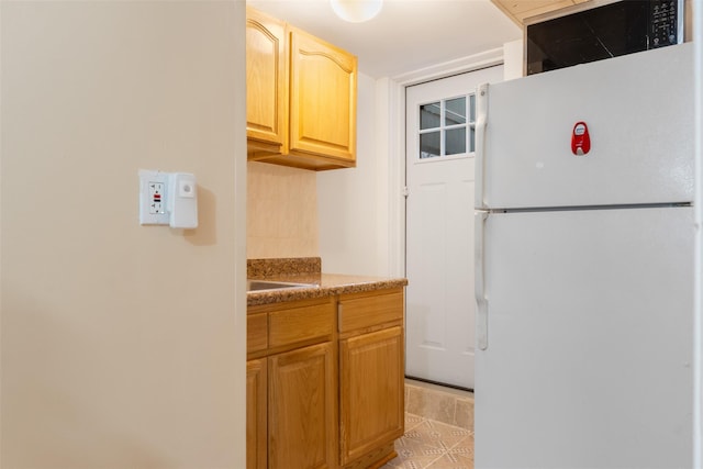 kitchen with freestanding refrigerator