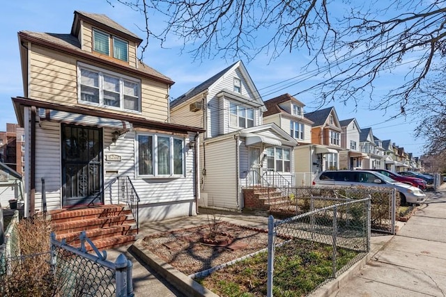 traditional style home with a fenced front yard and a residential view